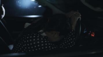 Stressed woman is crying and face down on the steering wheel. sad and crying in car. Sad, depressed from health problems, feeling sad and reflective, emotional expression, brokenhearted concept. video