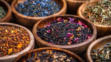 Many different types of tea in wooden bowls photo