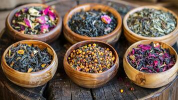 A variety of different types of tea in wooden bowls photo