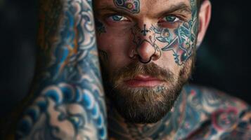 A man with tattoos on his face and arms photo