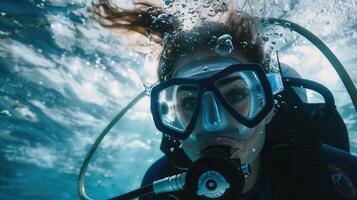 A woman scuba diving in the ocean photo
