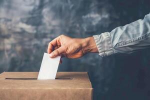 A hand putting a paper into a box photo