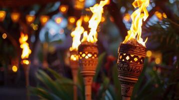 Tiki torches lit up in the dark photo
