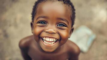 A smiling little boy with blue eyes photo