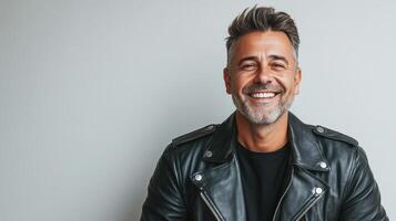 A man in a leather jacket smiling photo