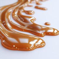 Drizzle of caramel sauce creating an abstract pattern on a pristine white background smooth and glossy photo
