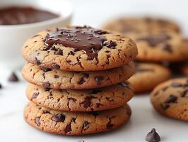 Stack of chocolate chip cookies with melted chocolate drizzled on a clean white background rich and indulgent photo