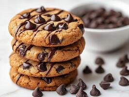 Stack of chocolate chip cookies with melted chocolate drizzled on a clean white background rich and indulgent photo