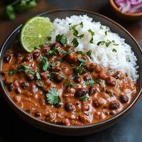 Steaming plate of rajma chawal with creamy rajma curry and fragrant basmati rice garnished with fresh coriander photo