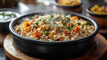 Steaming plate of veg pulao with mixed vegetables and fragrant spices served with a side of raita photo