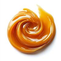 Swirl of caramel sauce drizzled artistically on a white background smooth and glossy photo