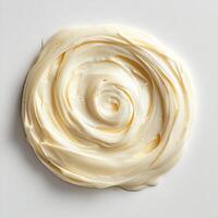 Swirl of creamy Alfredo sauce on a pristine white background smooth and rich in texture photo
