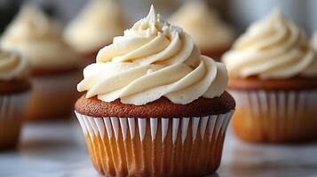 Swirl of vanilla buttercream frosting on a cupcake placed on a white background creamy and smooth photo