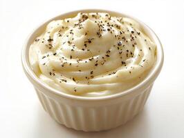 Creamy ranch sauce a small bowl with a drizzle of sauce splashed on the white background photo