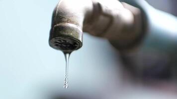 A close up of a water pipe with a drop of water video