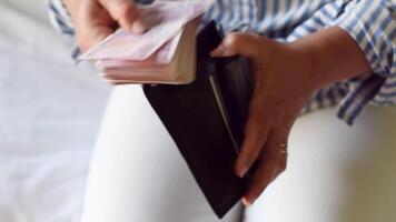 woman holds large stack of 200 Turkish lira bills in front of her, spreads it with a fan and shows it to the camera, a lot of money, but little value, high inflation in Turkey video