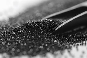 Close-Up of Black Sand with Shovel in Bokeh Effect Abstract Background for Design Projects photo