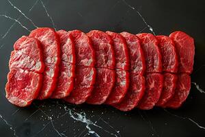 Fresh Slices of Raw Beef Steak on Black Marble Background - Perfect for Cooking and Culinary Designs photo