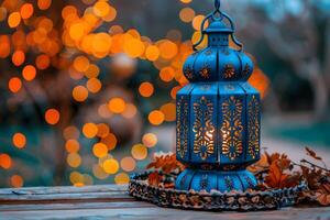 Elegant Blue Lantern with Intricate Designs Illuminated by Warm Bokeh Lights for Festive Decorations photo
