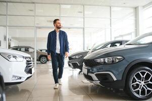 Man customer male buyer client chooses auto wants to buy new automobile photo