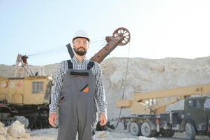 Worker and quarry in background photo