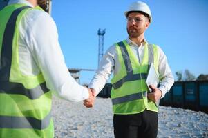 Two engineers at a stone crushing plant. The concept of quarrying. photo