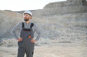 Portrait of a worker standing on the background of a stone quarry photo