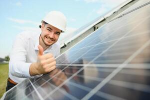 The solar farm, solar panel with engineer check the operation of the system, Alternative energy to conserve the worlds energy, Photovoltaic module idea for clean energy production. photo