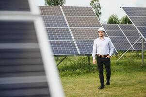 The solar farm, solar panel with engineer check the operation of the system, Alternative energy to conserve the worlds energy, Photovoltaic module idea for clean energy production. photo