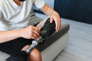 Close-up elevated view of a man adjusting the screws on an artificial prosthetic leg photo
