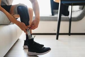 Close-up elevated view of a man adjusting the screws on an artificial prosthetic leg photo