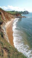 Turquoise water crashing on secluded beach below green cliffs photo