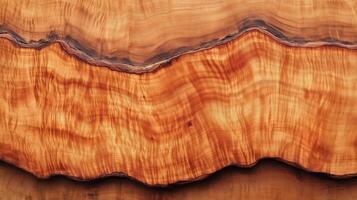 A wooden surface with a brown color. The surface has a wavy texture, and it is a piece of wood with a natural grain. photo