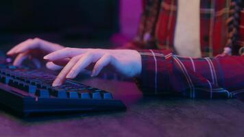 Close up hands girl woman female student gamer streamer hacker coder programmer business worker desk computer typing code data keyboard work study cyber gaming addiction play game in neon light video