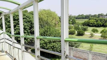 a balcony with a railing and green railings video