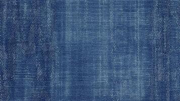 A blue denim fabric with a zigzag pattern. The fabric is blue and has a rough texture. photo