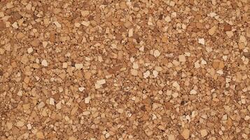 A close up of a tan colored surface with many small pieces of material. photo