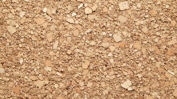 A close up of a tan colored surface with many small pieces of material. photo