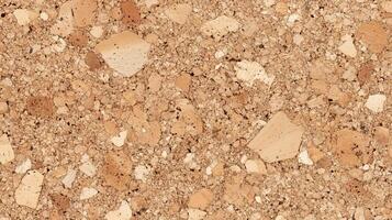 A close up of a tan colored surface with many small pieces of material. photo