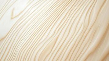 A wooden surface with a grainy texture. The wood appears to be of a light color, possibly beige or tan. The grain of the wood is visible, with some lines and patterns that create a sense of depth photo