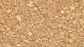 A close up of a tan colored surface with many small pieces of material. photo