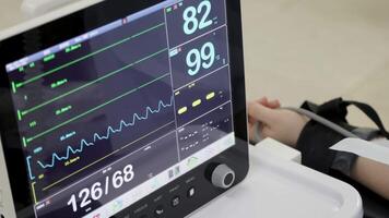 Close-up of a patient monitor displaying oxygen saturation levels, with a focus on the detailed readout. The image highlights the critical monitoring of vital signs in a clinical setting video