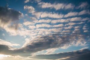 Dramatic sky with sunlight and clouds creates serene atmosphere photo