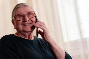 Senior woman uses a mobile device to communicate with close relatives, embracing technology to maintain meaningful connections photo