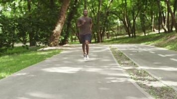 Intensive workout. Black guy checking his activity status on smartwatch during run, close up video