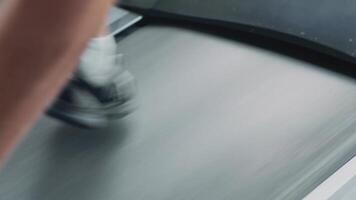 Warm up before exercise program. Close up of man doing slow cardio endurance workout on treadmill video