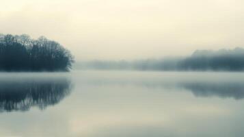 A foggy morning with a lake in the background photo