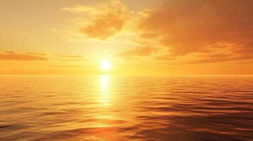 The sun is setting over the ocean, casting a warm glow on the water photo