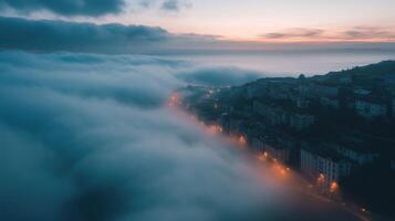 A foggy cityscape with a cloudy sky and a sunset in the background photo