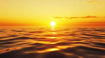 The sun is setting over the ocean, casting a warm glow on the water photo